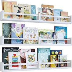 three white bookshelves filled with children's books