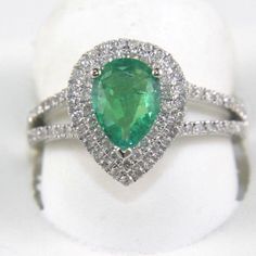 This Is A Fancy Fine Pear Cut Emerald Solitaire Bridge Ring W/Diamond Halo And Accents. It Is Made Of 100% Natural 14kt White Gold And Is In Brand New Condition. It Has A Ctw Of 1.46ct (0.53 Diamond/0.93 Emerald) And Weighs 3.7 Grams. The Fancy Diamonds Have A Clarity Of Si1 And F Color. This Beautiful Custom Piece Has An Excellent Pear Cut Emerald Stone, Surrounded By A Diamond Halo With Accents Running Along The Band. Fine Jewelry Emerald Ring With Cluster Shape In Platinum, Fine Jewelry Platinum Emerald Cluster Ring, Fine Jewelry Platinum Cluster Emerald Ring, Emerald Cluster Ring With Brilliant Cut Diamonds, Gia Certified Pear-shaped Diamond Emerald Ring, White Gold Emerald Ring With Brilliant Cut Cluster, Gia Certified White Gold Emerald Diamond Ring, White Gold Cluster Emerald Ring With Brilliant Cut, Gia Certified Pear-shaped Platinum Jewelry