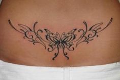 a woman's stomach with a butterfly tattoo on the side of her belly,