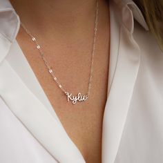 Escape to the Amalfi coast with our beautiful Amalfi Name Necklace! Its delicate design will turn heads and inspire confidence - making you feel like you can conquer anything! NECKLACE FEATURES Choice of 18k gold plating over sterling silver or Sterling Silver handcrafted custom name pendant (approx.* 1", up to 10 characters) Choice of Metal: Gold Fill or Sterling Silver Choice of Chain Style: Cable Chain or Upgraded Specialty Link Chain All necklace findings are gold filled/sterling silver. Eac Silver Name Chain, Name Chain Gold Design, Name Chain, Silver Name Necklace, Name Pendant, The Amalfi Coast, Freshwater Pearls Earrings, Delicate Design, Chain Extenders