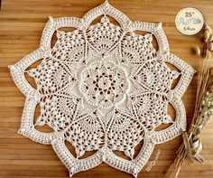 a white doily sitting on top of a wooden table