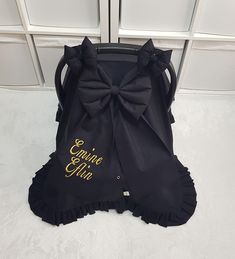 a black purse with a large bow on it