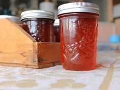 three jars of jam sitting on top of a table