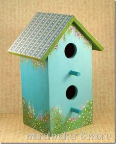 a blue birdhouse sitting on top of a table