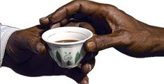 two hands holding a coffee cup in their left hand