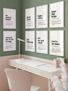 a white desk sitting in front of a green wall with posters on the wall above it