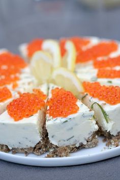 there is a cake with orange and white toppings on the plate, ready to be eaten