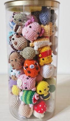 a jar filled with lots of small crocheted animals