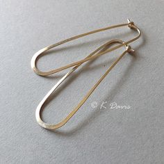 Modern gold filled version of a classic style. 2 inch long loop hoop earrings; slender hoops. Hand crafted and formed into along oval loop; hammered, sanded and polished to a soft shine. The rounded elongated dangle shape looks great on almost every face shape. These 14k gold filled hoops measure approximately 2 inches long (~ 5 cm) and ~5/8 inch wide at the base. See measurement/ reference photo to get an accurate idea of length and width. These are long slender hoops. To find the shorter 1 1/8 Minimalist Oval Metal Hoop Earrings, Statement Earrings Silver, Sleeper Earrings, Silver Statement Earrings, Gold Filled Hoops, Womens Jewelry, Face Shape, Gold Hoops, Gold Hoop