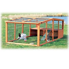 an outdoor rabbit hut with two rabbits in it