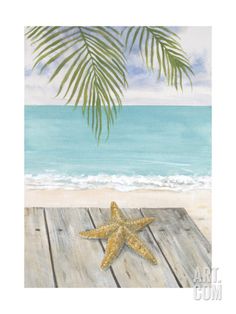 a starfish sitting on top of a wooden table next to the ocean with a palm tree