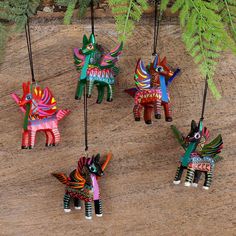 four colorfully painted horses hanging from strings