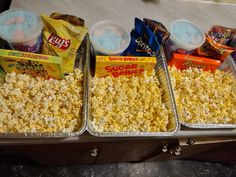 three trays filled with different types of snacks