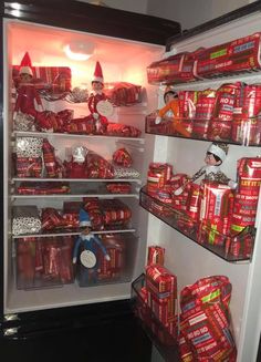 an open refrigerator filled with lots of wrapped presents