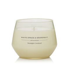 yankee candle white spruce and grapefruit in a clear glass on a white background