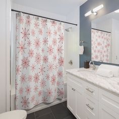 a bathroom with a shower, sink and toilet covered in red snowflakes