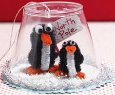 two penguins in a glass bowl with a sign on the top that says happy new year