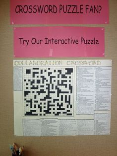 a crossword puzzle is hanging on the wall next to a pink sign that says try our interactive puzzle