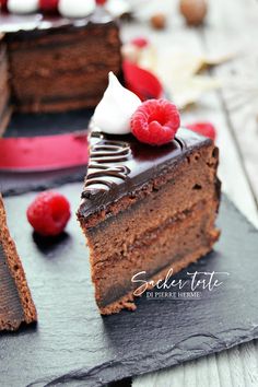 two pieces of chocolate cake with raspberries on top