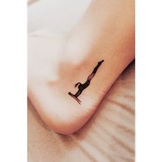 a woman's foot with a small tattoo of a dog on the bottom of it