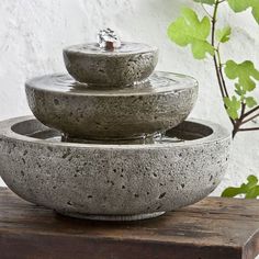 three stone bowls are stacked on top of each other with water running down the sides