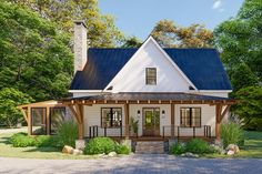 a white house with a blue roof in the middle of some trees and grass,