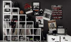 a black and white room with various records on the wall