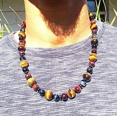 Men's Beaded Tiger Eye Necklace💥 Incredible Energy: You can feel this necklace when you put it on. A gentle but noticeable vibration is emitted from this combination of stones. A sense of knowing that you are a safe and all is well.💪 Large Powerful Stones: We use 10mm yellow tiger eye gives confidence. The 16mm blue tigers eye helps empower the voice and boost confidence. The hematite spacers serve as a conductor and grounding agent for this powerful piece of jewelry.📏 Size: The interior of t Beaded Tiger, Blue Chakra, Tiger Eye Necklace, Mens Beaded Necklaces, Tigers Eye Necklace, Boost Confidence, Beaded Jewlery, Black Onyx Necklace, Blue Tigers