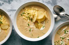 three bowls filled with soup and potato chips