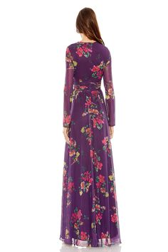 a woman wearing a long purple dress with floral print on the sleeves and waistline