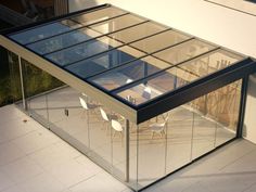 a glass house sitting on top of a white tiled floor