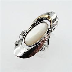 LONG and BEAUTIFUL Mother of pearl ring, inlaid in solid sterling silver decorated with a yellow gold frame, a unisex statement ring, Length: 35 mm / 1.1 in., Width:18 mm / 0.6 in. Available in many other stones. Labeled and stamped 925. This beautiful set will be sent to you in a gift box. Please feel free to contact us for any matter. Metal: Sterling Silver 925 9K Yellow Gold Gemstone: Mother of pearl, Oval 20mm X 10mm Available to be made in many other gemstones, please feel welcome to be cre Unique White Pearl Ring For Formal Occasions, White Pearl Open Ring With Polished Finish, Unique Oval White Pearl Ring, Unique White Oval Pearl Ring, Sterling Silver Opal Ring, White Stone Ring, Mother Of Pearl Ring, Silver Pearl Ring, Silver Opal Ring