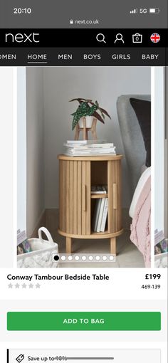 a small wooden table with books on it and a plant in the corner next to it