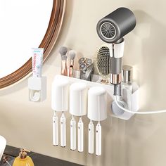 the hair dryer is hanging on the wall next to some brushes and other items