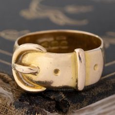 A delicious antique English buckle band, fit with Victorian hallmarks and perfect patina. When it comes to antique and vintage jewelry collecting, there is nothing more classic than an antique buckle band. Representative of loyalty, protection, and eternal love - as the belt curves around and loops back into itself. We love the slightly larger width and charming engravings on this one, a perfect gold bold ring. 18kt yellow gold Size 7.75 & resizable 10.89mm wide Please see qualitative report for Luxury Adjustable Jewelry With Antique Buckle, Classic Gold Antique Buckle Belt Buckles, Classic Antique Gold Belt Buckle, Classic Gold Antique Belt Buckle, Vintage Adjustable Belt Buckles For Formal Wear, Vintage Adjustable Gold Belt, Gold Antique Buckle Vintage Belt Buckles, Vintage Gold Belt Buckle With Antique Detail, Gold Antique Buckle Vintage Belt Buckle