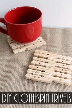 wooden clothespin trivets sitting on top of a table next to a red cup