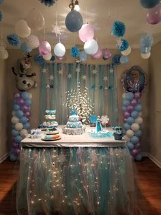 a birthday party with balloons, cake and decorations