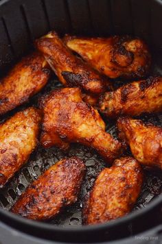 chicken wings cooking in an air fryer