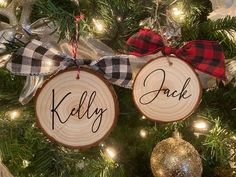 two wood slices with the words kelly and jack on them hanging from a christmas tree