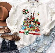 Disney White Christmas Tops, Disney White Sweatshirt With Cartoon Print, Disney Cotton T-shirt For Winter, Disney White Cartoon Print Sweatshirt, White Disney Character Print Sweatshirt For Fan Events, White Disney Cotton Sweatshirt, White Letter Print Sweatshirt For Disney Fan Events, White Disney Cartoon Print Sweatshirt, White Letter Print Sweatshirt For Disney Events