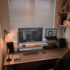 a computer desk with two monitors, keyboard and mouse on it in front of a window