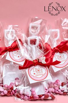 small candy bags with valentine's day tags on them and red ribbons tied around them