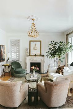 a living room filled with furniture and a fire place in the middle of a room