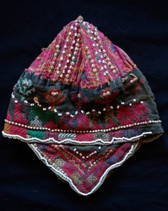 This is a cap from the Swat Valley in Pakistan. The Swat Valley is know for it's beautiful silk embroidered textiles. It is made of a cotton fabric embroidered in silk and decorated with glass and metallic beads. -Silk embroidery -Glass and metallic beads -Swat Valley Multicolor Embroidered Fabric For Ceremonial Use, Traditional Embellished Embroidered Fabric For Ceremonies, Multicolor Embroidered Hats For Festivals, Traditional Embroidered Wedding Hats, Embroidered Fabric For Ceremonial Festival, Traditional Embroidered Hats For Ceremonial Use, Bohemian Multicolor Embroidered Fabric For Ceremonial Use, Bohemian Embellished Embroidered Fabric For Festivals, Bohemian Embroidered Hats For Festivals