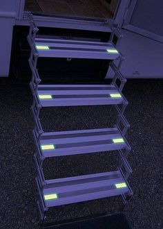 there is a set of stairs that are lit up with neon lights on the side