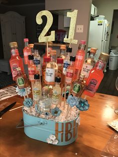 a blue bucket filled with lots of bottles and condiments on top of a wooden table