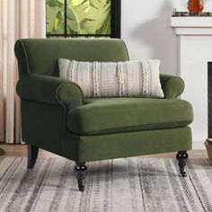 a green chair sitting on top of a rug in front of a fire place and window