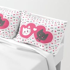 two pillows with hearts and cats on them