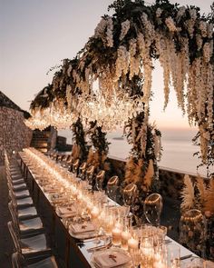 a long table with candles and flowers on it