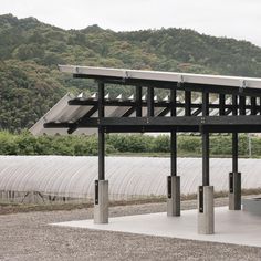 a large metal structure sitting in the middle of a field